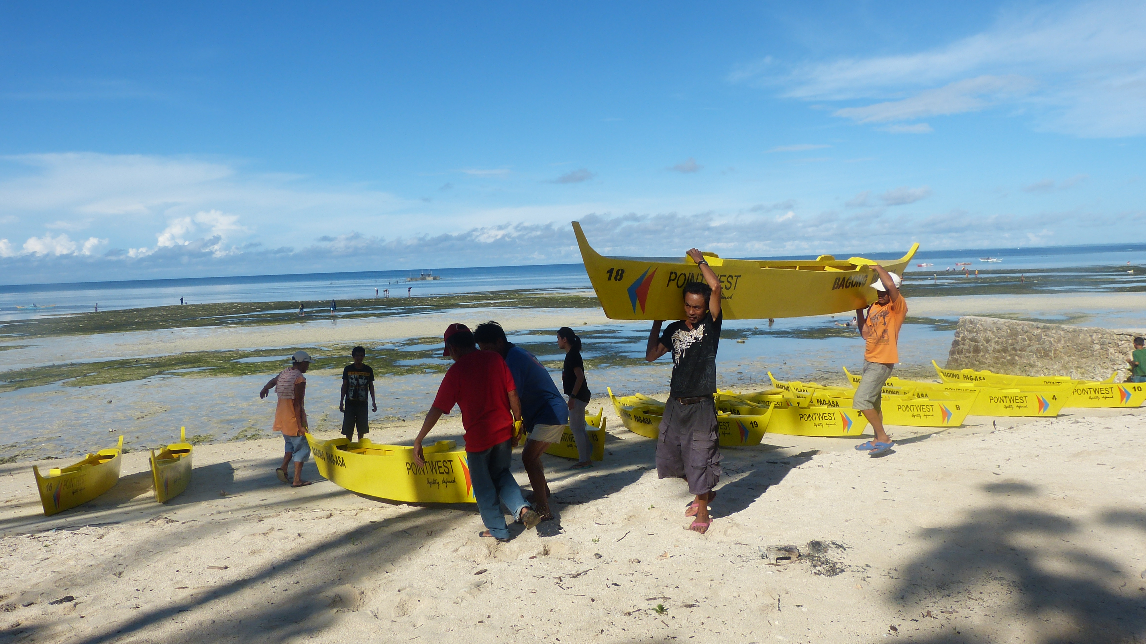 BAGONG PAG-ASA - Fishermen carrying the Yellow Boats